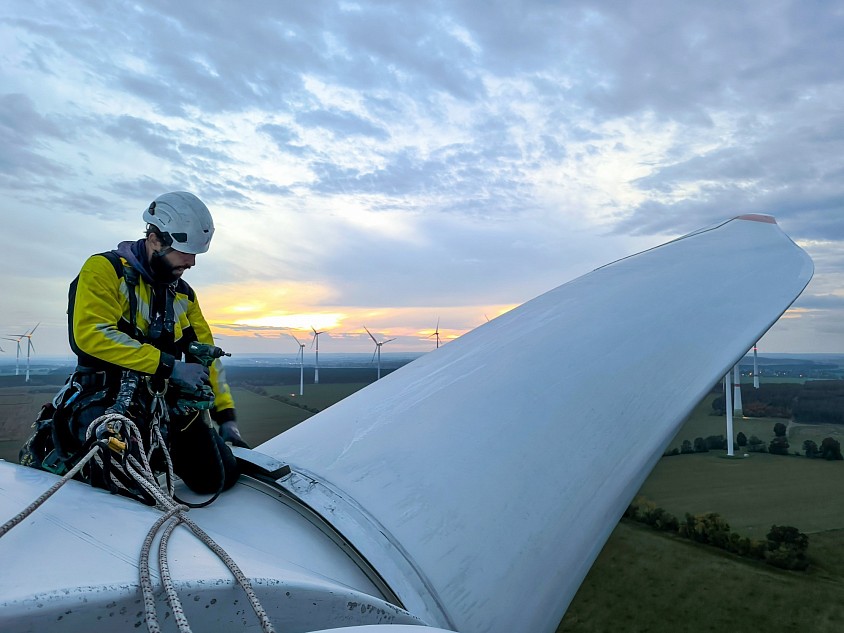 Ein Techniker(Seilzugang) bei der Arbeit auf der Windkraftanlage